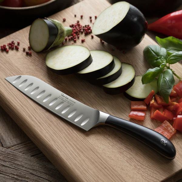 Robert Welch Signature Santoku Knife 17cm photographed on a cutting board