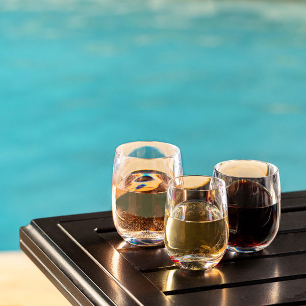 Oasis Unbreakable Stemless Wine Glasses next to a pool