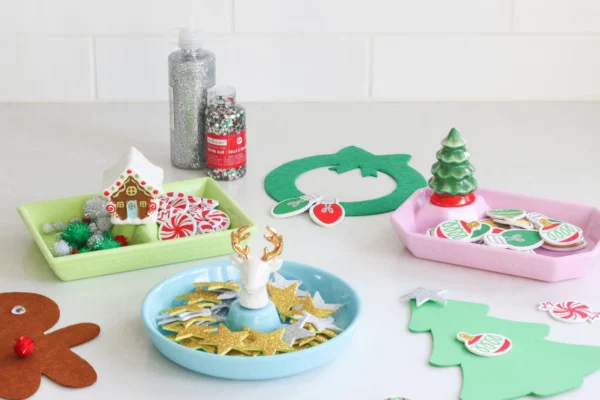 Nora Fleming Mini Christmas Tree pictured with other holiday themed minis attached to various colorful trays