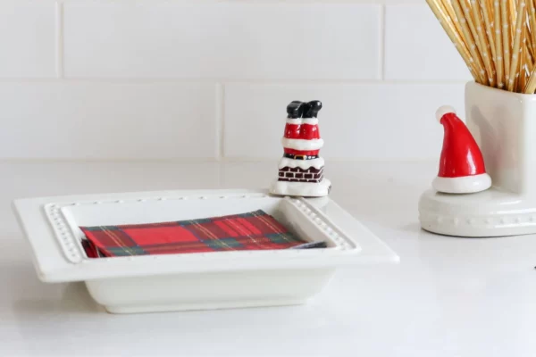 Nora Fleming Mini Santa legs Down the Chimney attached to a napkin tray