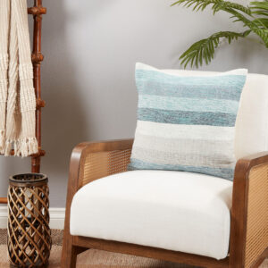 throw pillow with blue and beige stripes pictured on an armchair