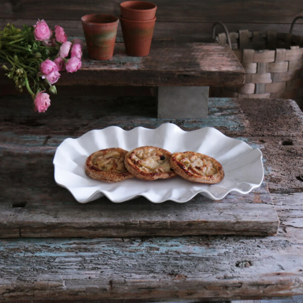 Bloom White Oval Platter holding English muffins