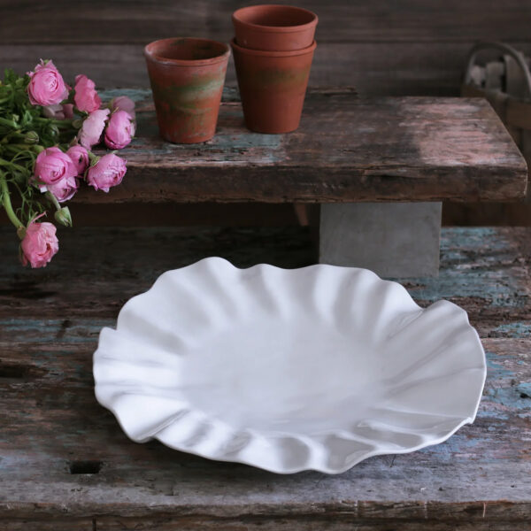 Bloom Large Round White Platter empty on table surrounded by flowers and pots