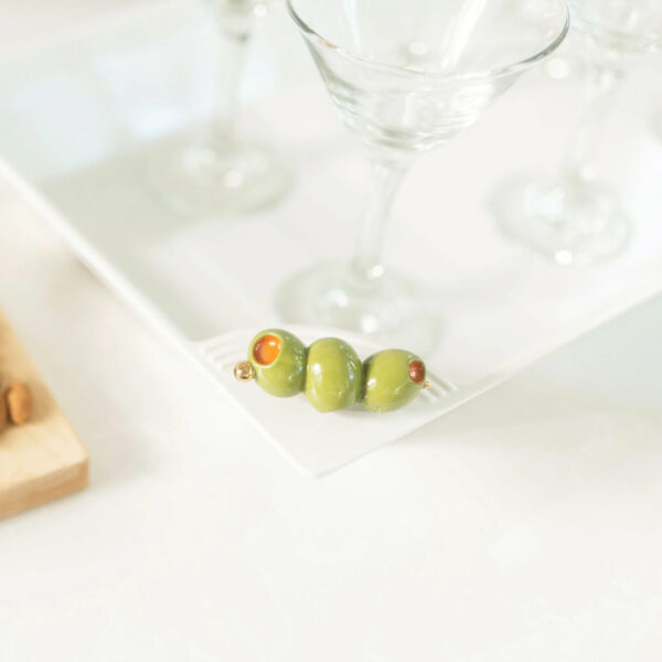 Nora Fleming Olive Mini A406 on a tray with wine glasses